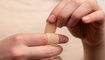 person with band aid on middle finger