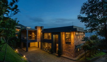 a house with a lot of windows lit up at night